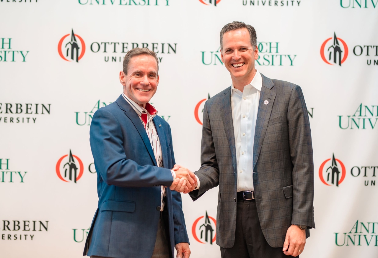 William R. Groves, J.D., Chancellor of Antioch University, and John Comerford, Ph.D., President of Otterbein University, shake hands 