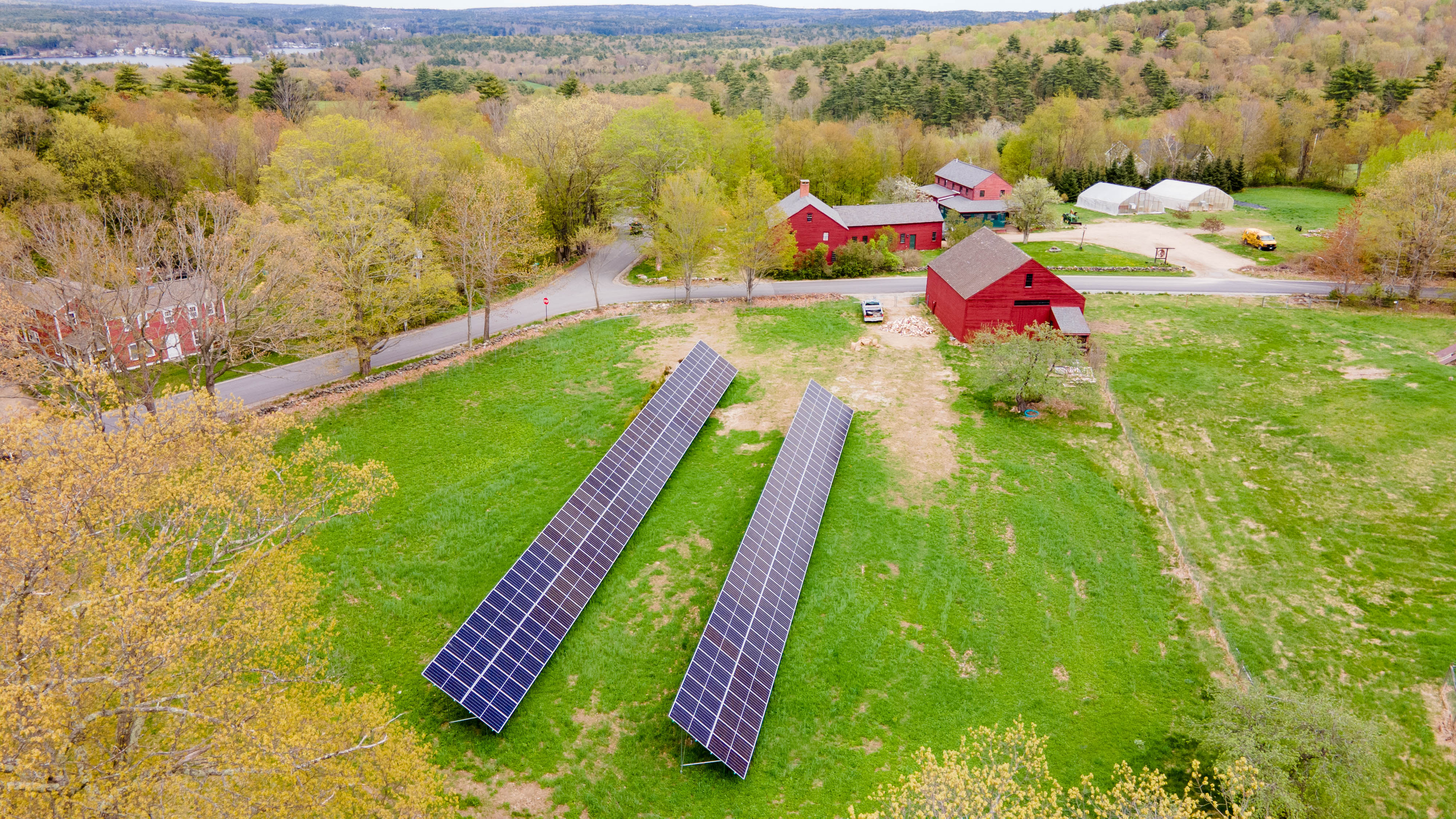 An aerial view of the Blasty Bough farm, including red barns and the solar array.