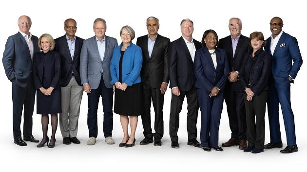 A group of people in business attire standing posed for the camera.