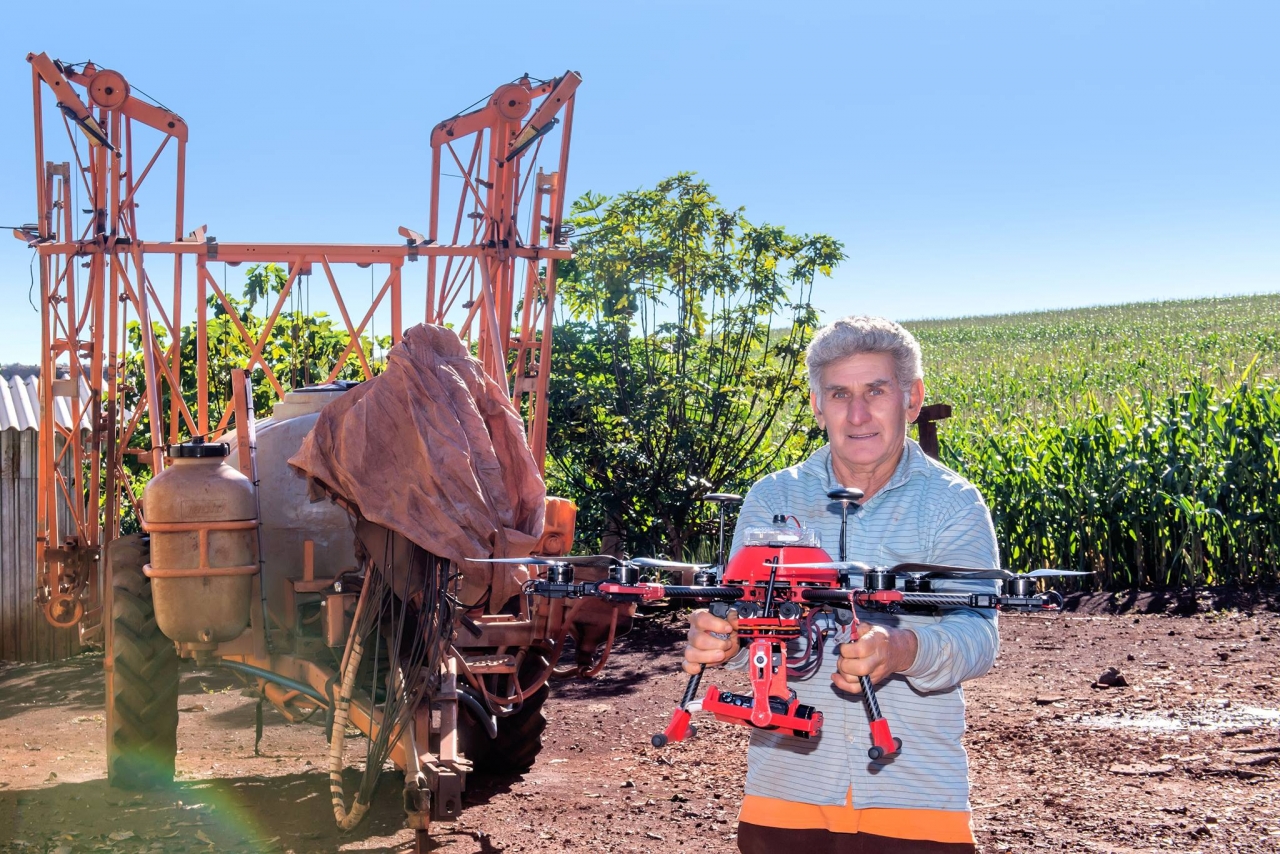 Man holding a drone on a farm
