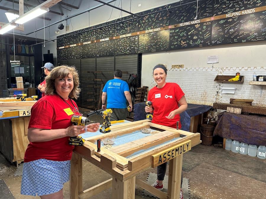 KeyBank volunteers prepare to assemble a bed frame.