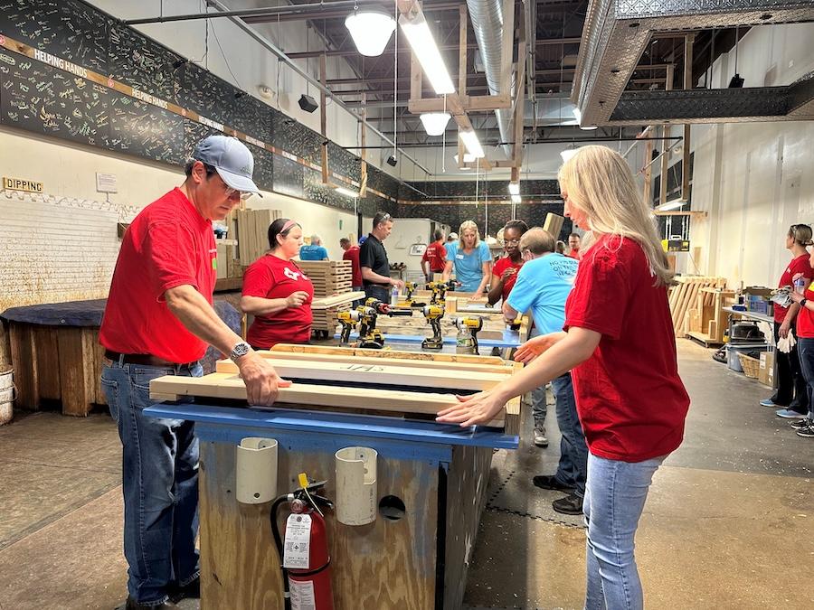 KeyBank volunteers install bed frames.