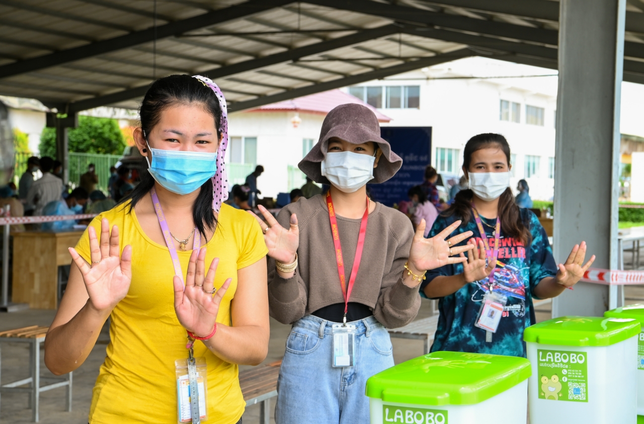 Factory workers at Sunbow factory, who are going to get their COVID-19 vaccines, wash their hands with Labobo, Kandal Stueng District in Kandal province, Cambodia, June, 2021.