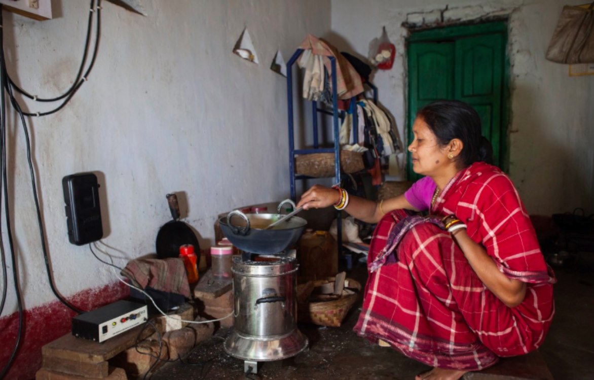 woman using clean cookstove