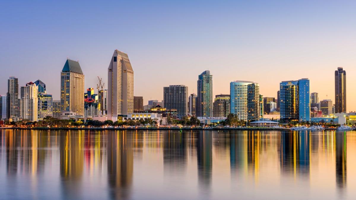 Cityscape shown in reflection of water.