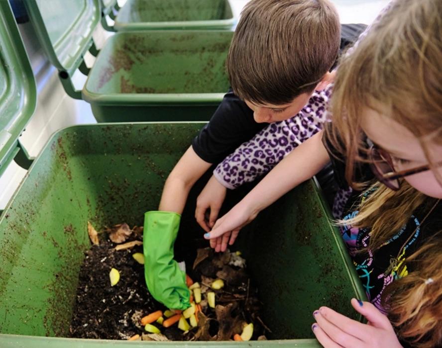kids working on composting