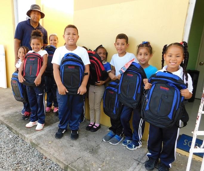 Children shown with their new back to school backpacks.