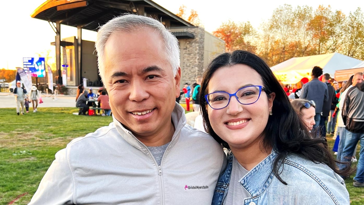 David Lin and Asalia Goldberg, others in a park setting behind them.