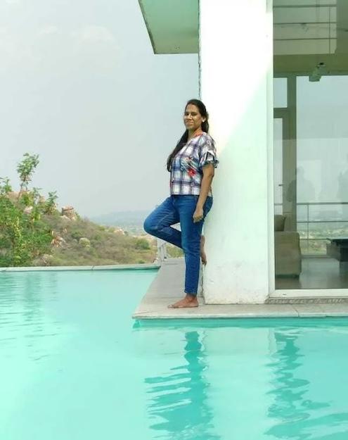 Deepthi shown at a swimming pool.