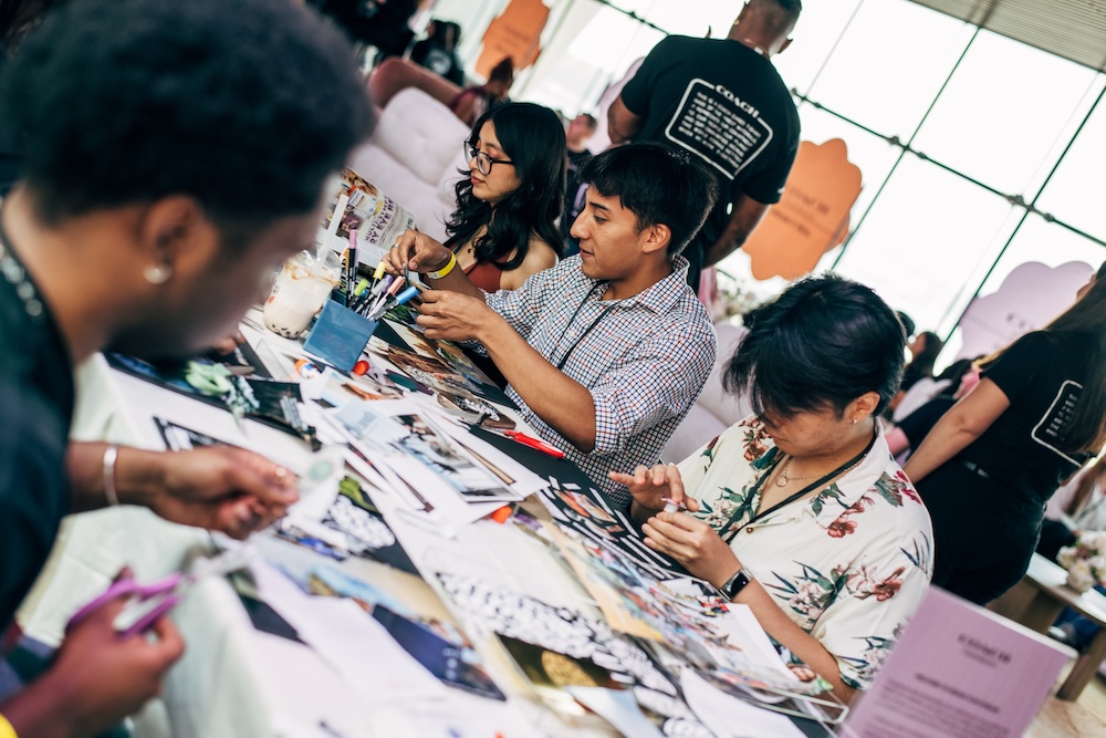 Group sitting at a table cutting paper and making artwork