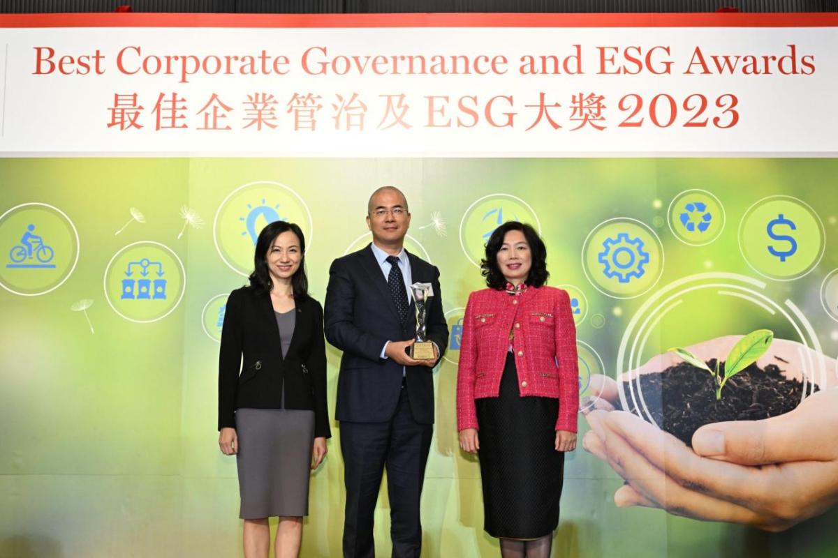 Three people stood together at the annual Best Corporate Governance and ESG Awards
