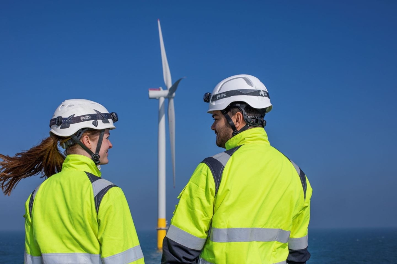 2 Orsted Apprentices pictured with turbine