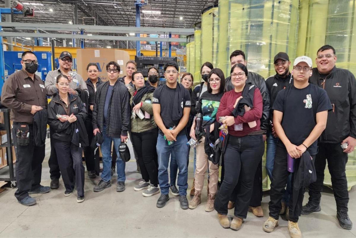 A group of people in a large warehouse.