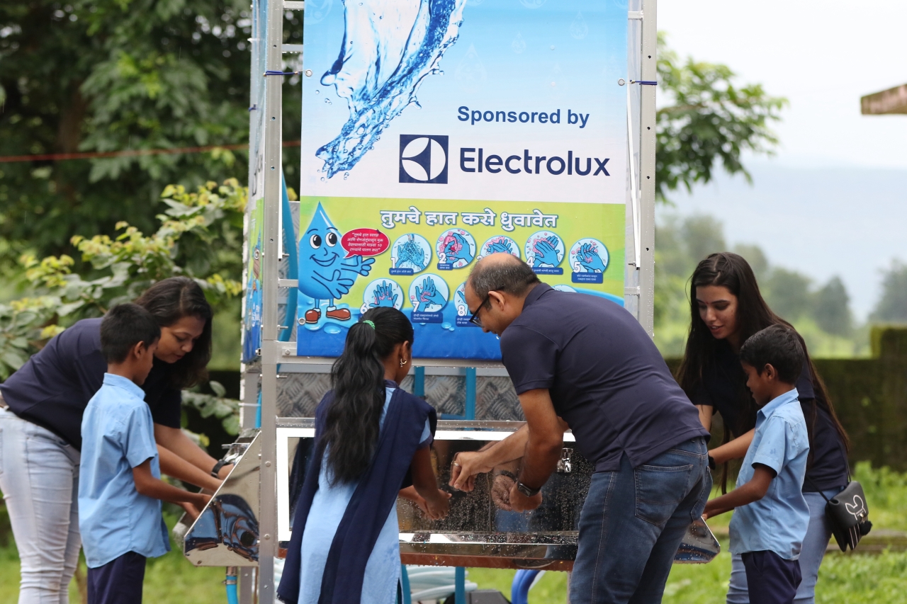 Electrolux volunteers showing children how to was their hands 