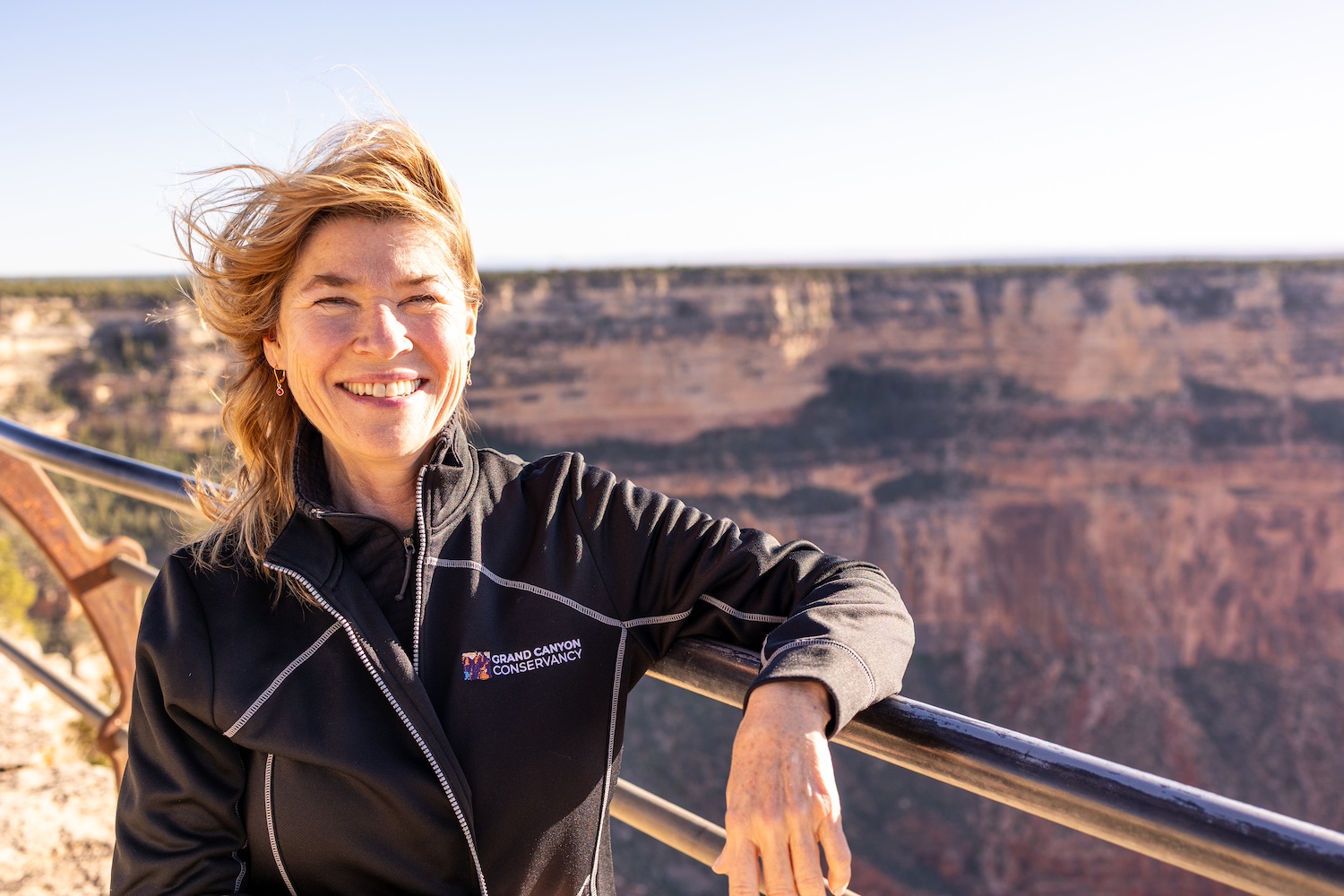 Elizabeth Silkes smiles at the camera with the Grand Canyon behind her — national parks