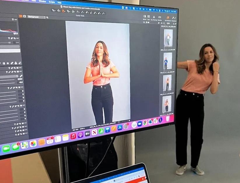 Emily Vaughn in front of a giant monitor. 