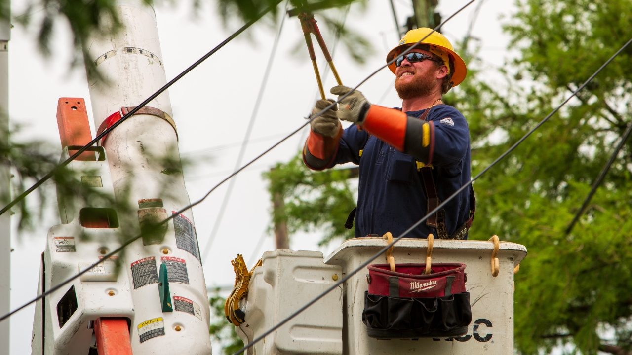 Entergy employee fixing power lines 
