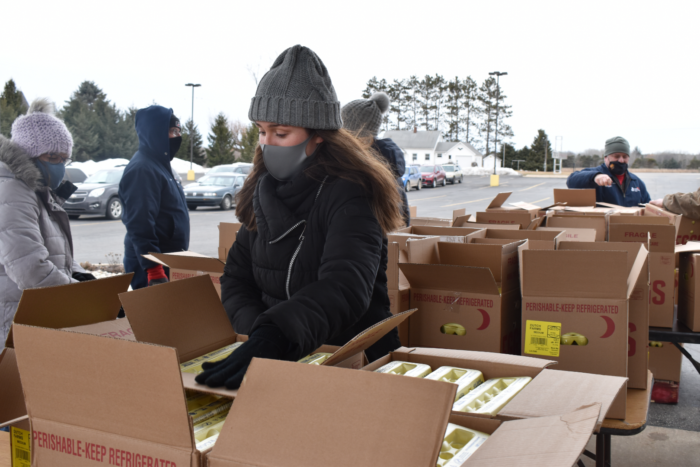 volunteer preparing supply boxes