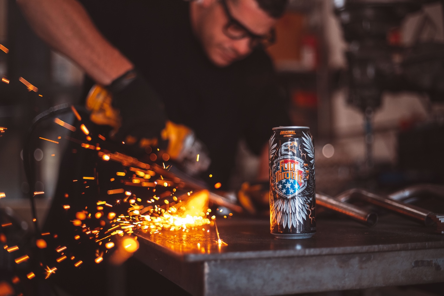 mechanic works on a custom motorcycle with Full Throttle energy drink