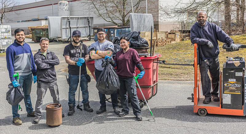 Team of volunteers cleaning outside