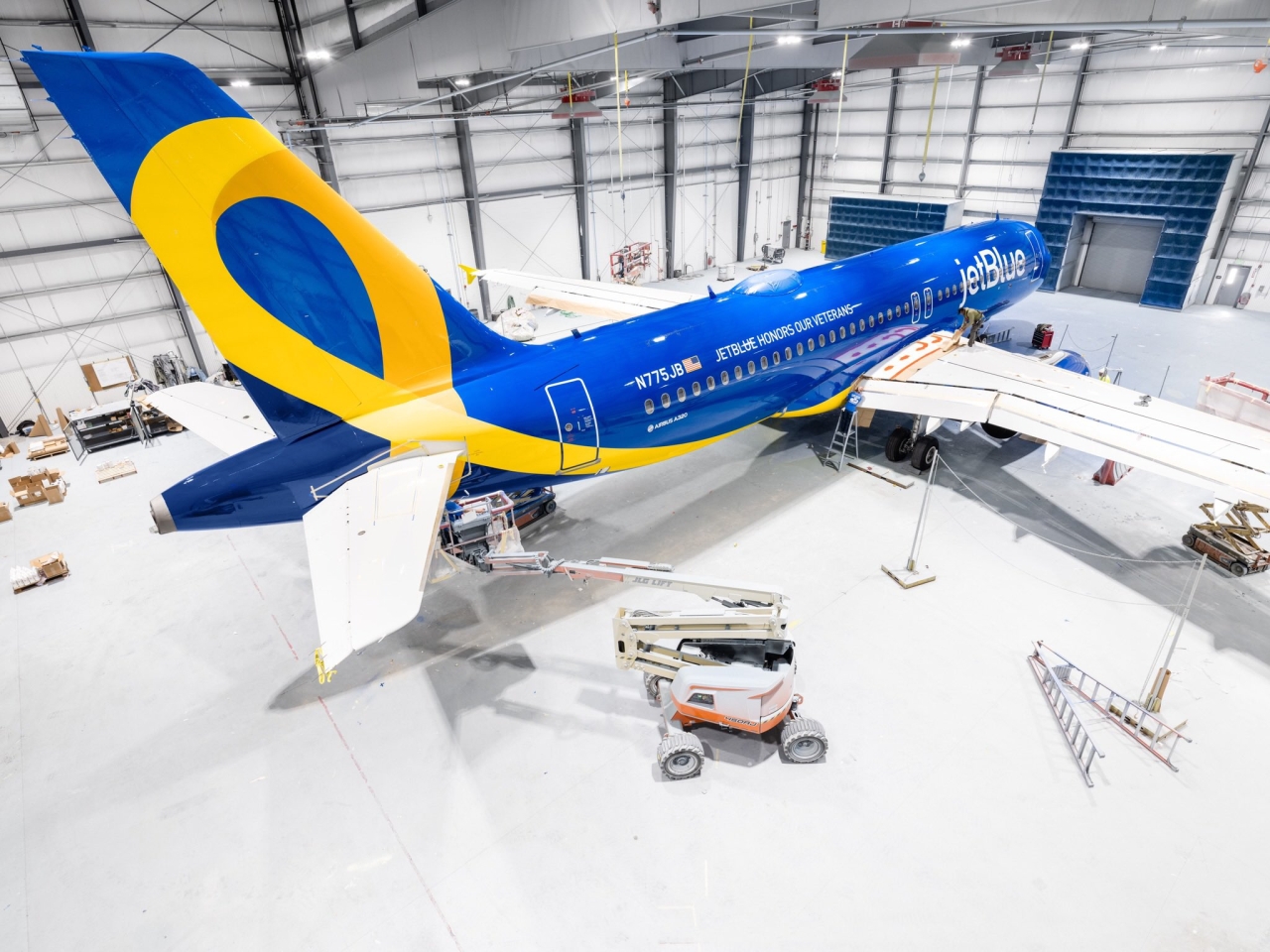 Blue and yellow airplane in hangar