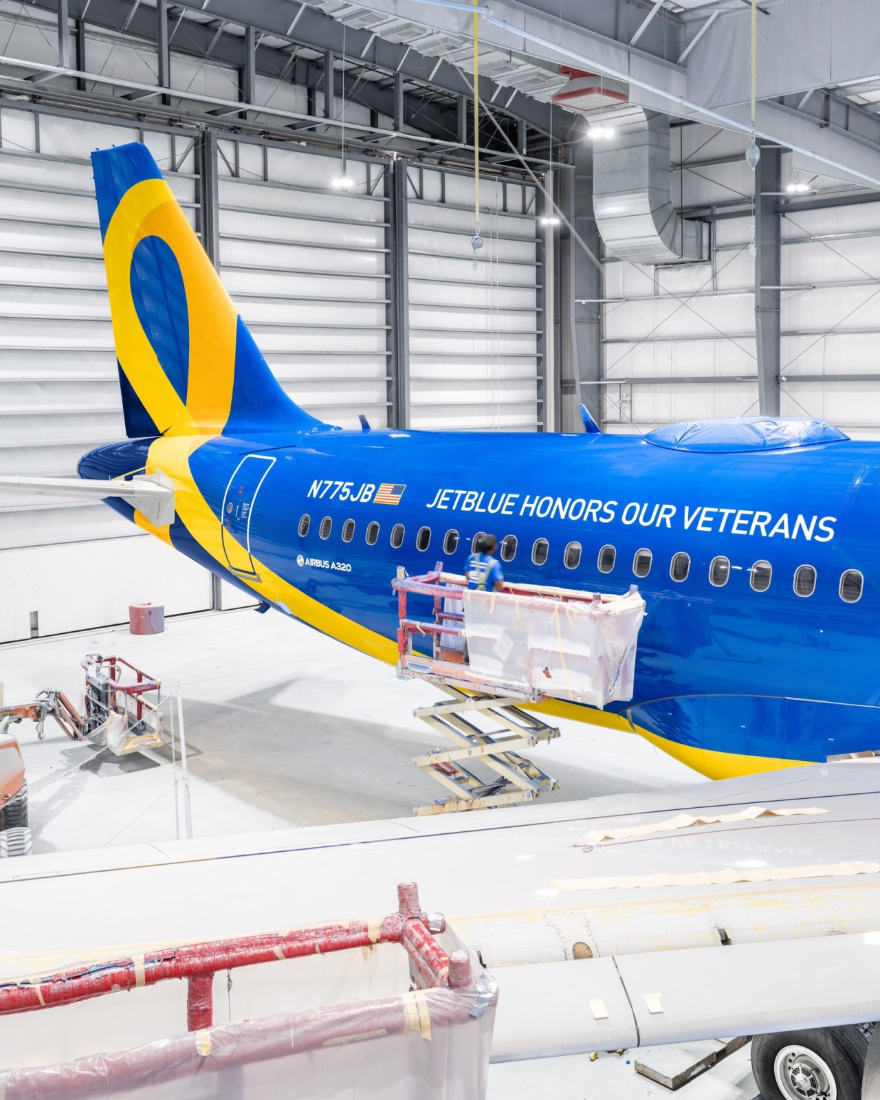 Blue and yellow airplane in hangar