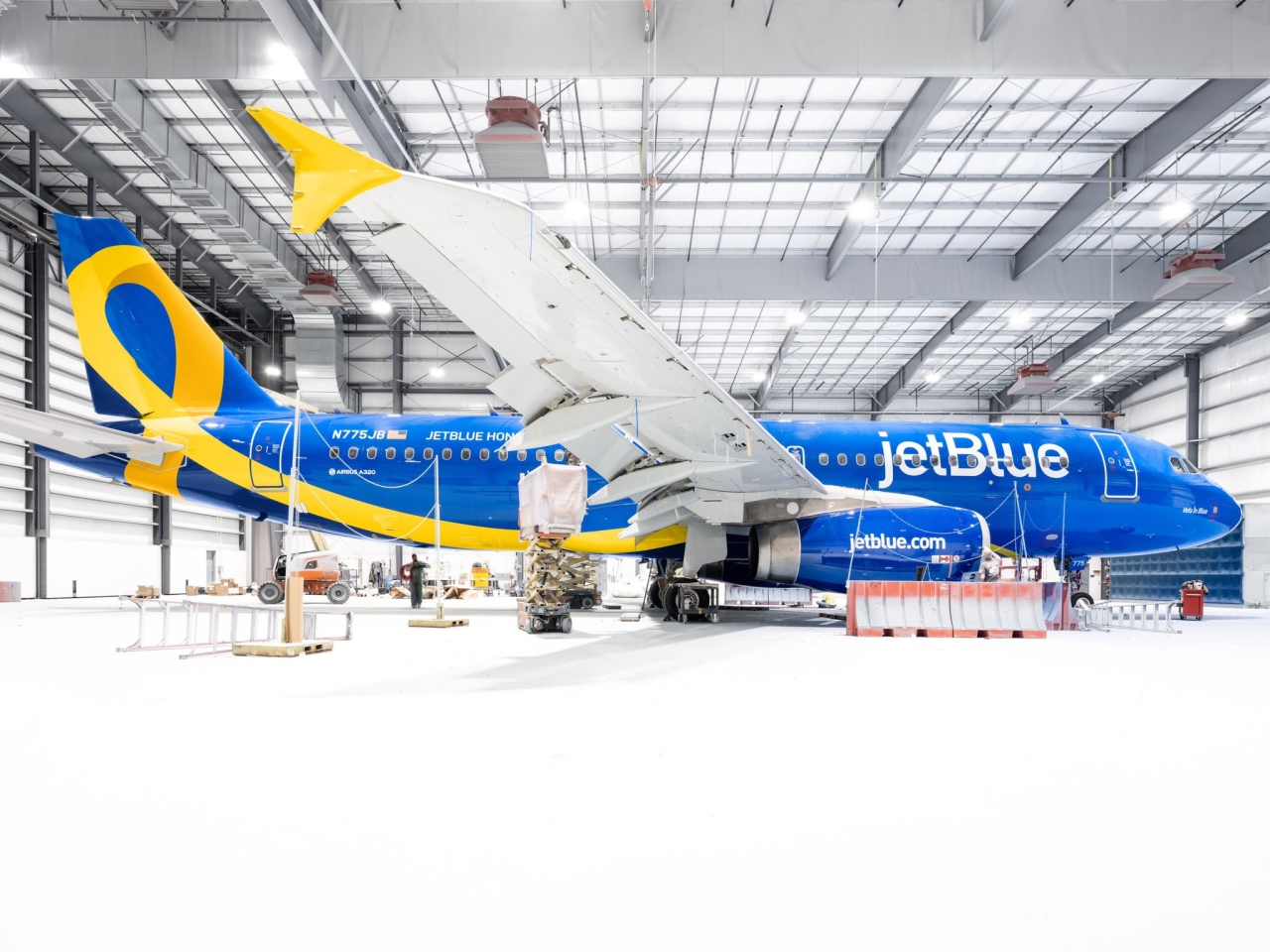 Blue and yellow airplane in hangar