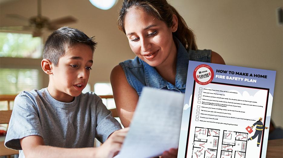 A woman and a young boy are shown looking at a fire safety check list.