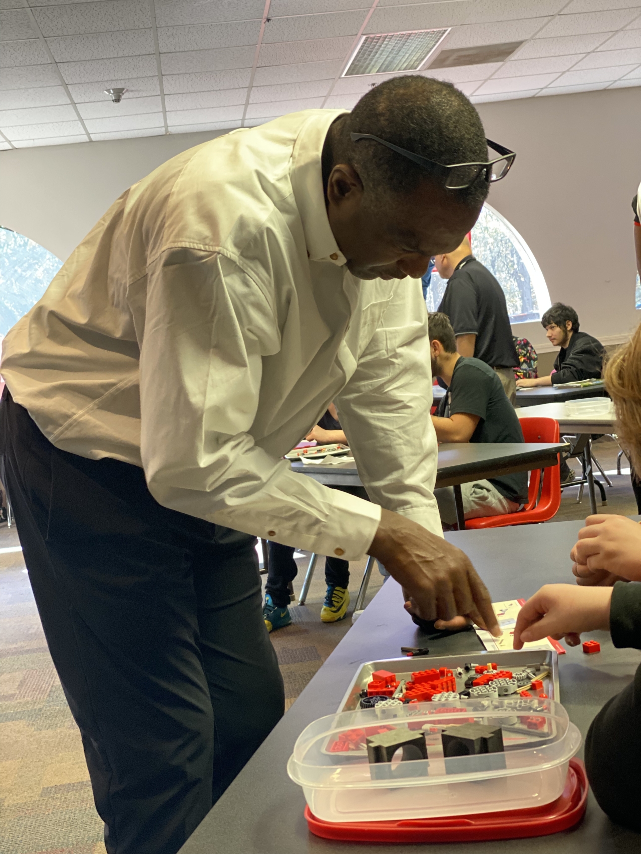 Cummins employee, Frank Griffin helps guide a team through the components of their engine build