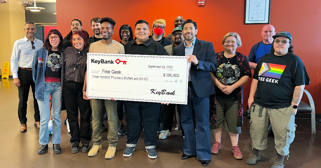 Representatives from Free Geek and KeyBank shown with a grant check for $300,000.