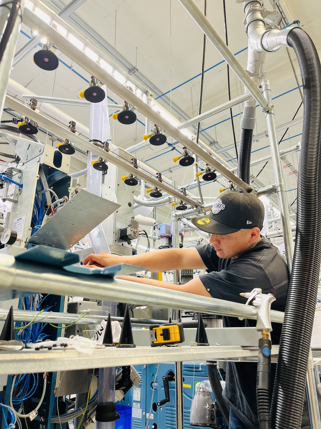 A FutureStitch employee works on a machine at the company's manufacturing facility. 