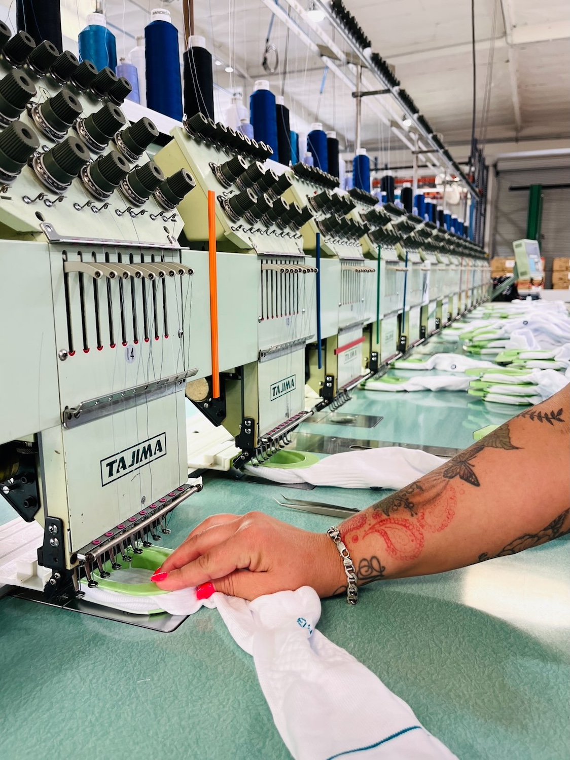 An employee sews socks at a FutureStitch manufacturing facility. 