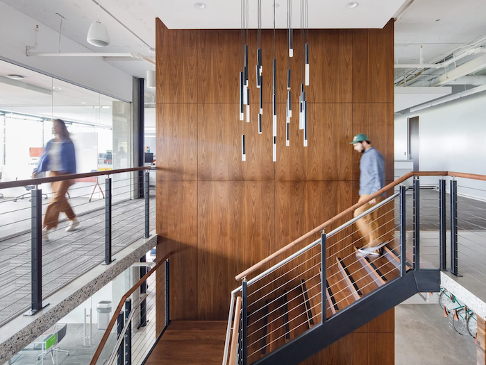 GoDaddy offices, Kirkland. Employee walking down a set of stairs.