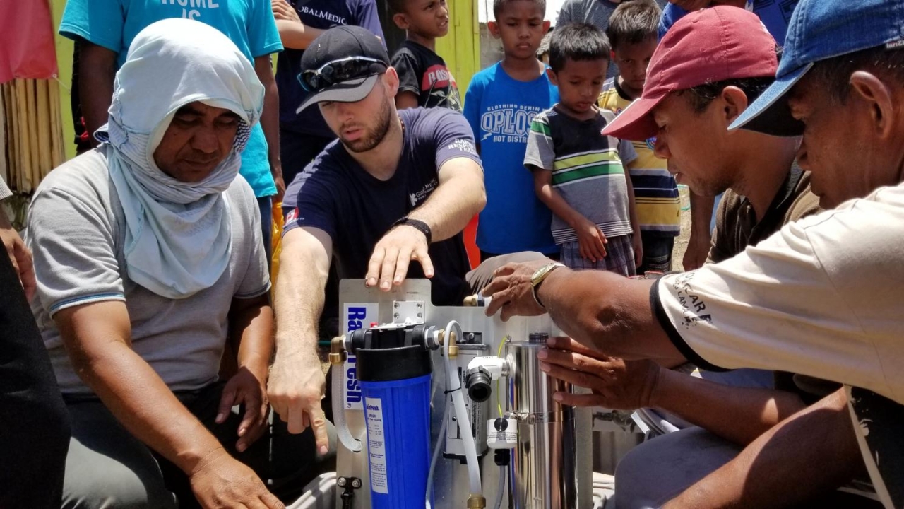 people working a water purifying machine