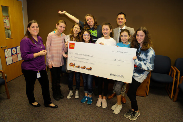 Students holding giant check