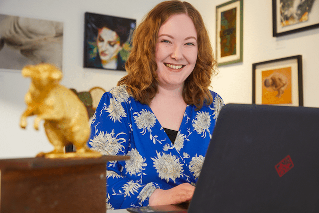 BobCat Gallery owner Catherine Sweet behind a laptop.