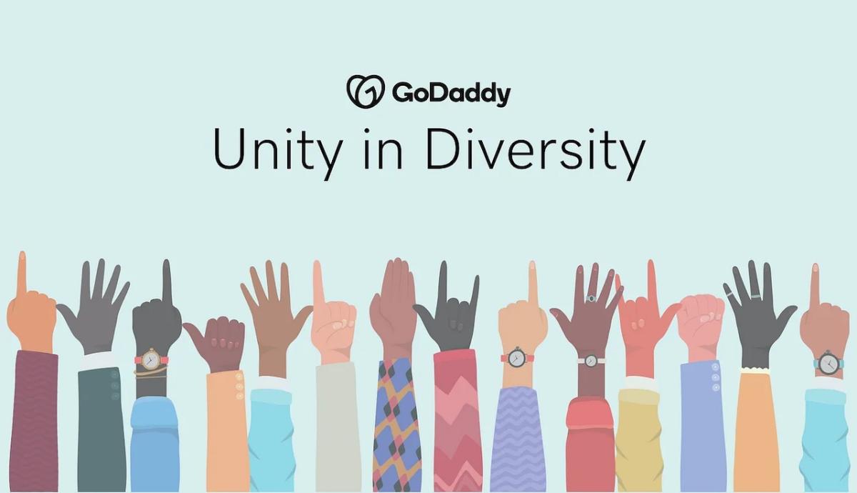 GoDaddy: Unity in Diversity. Hands of different colors raised.