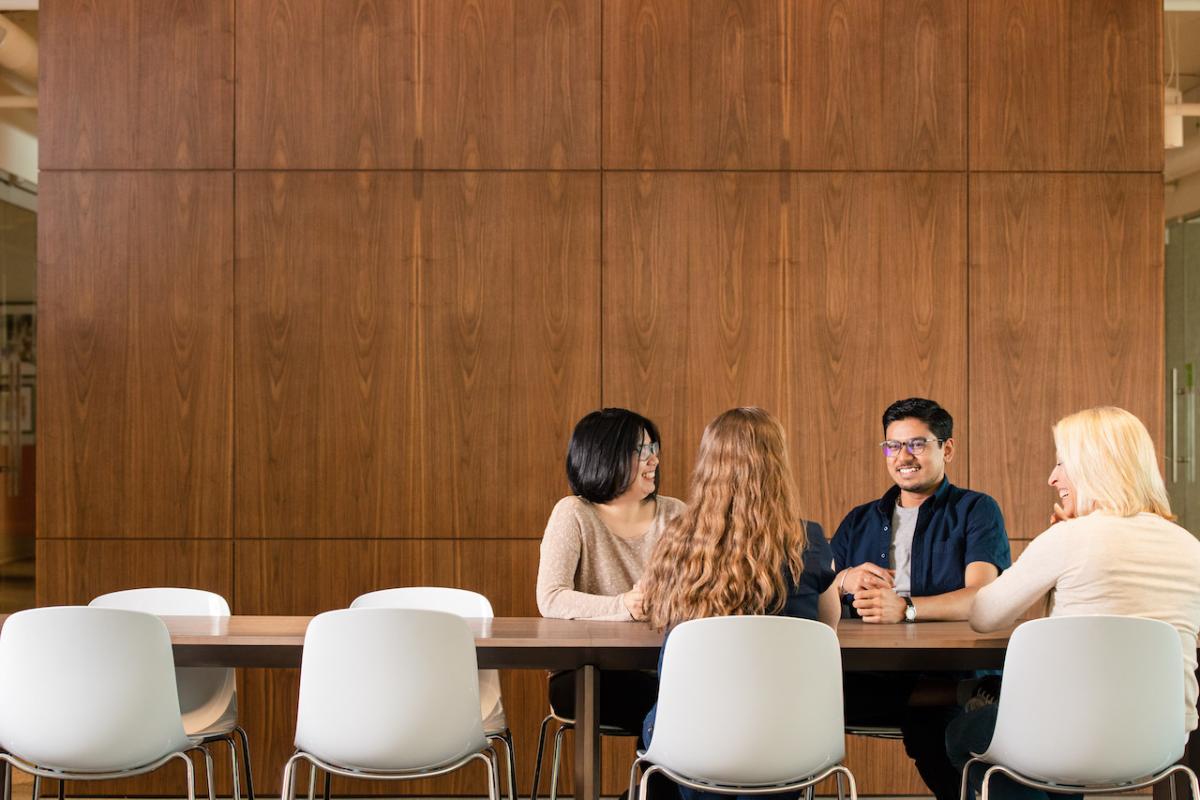 Four people sitting at a table.