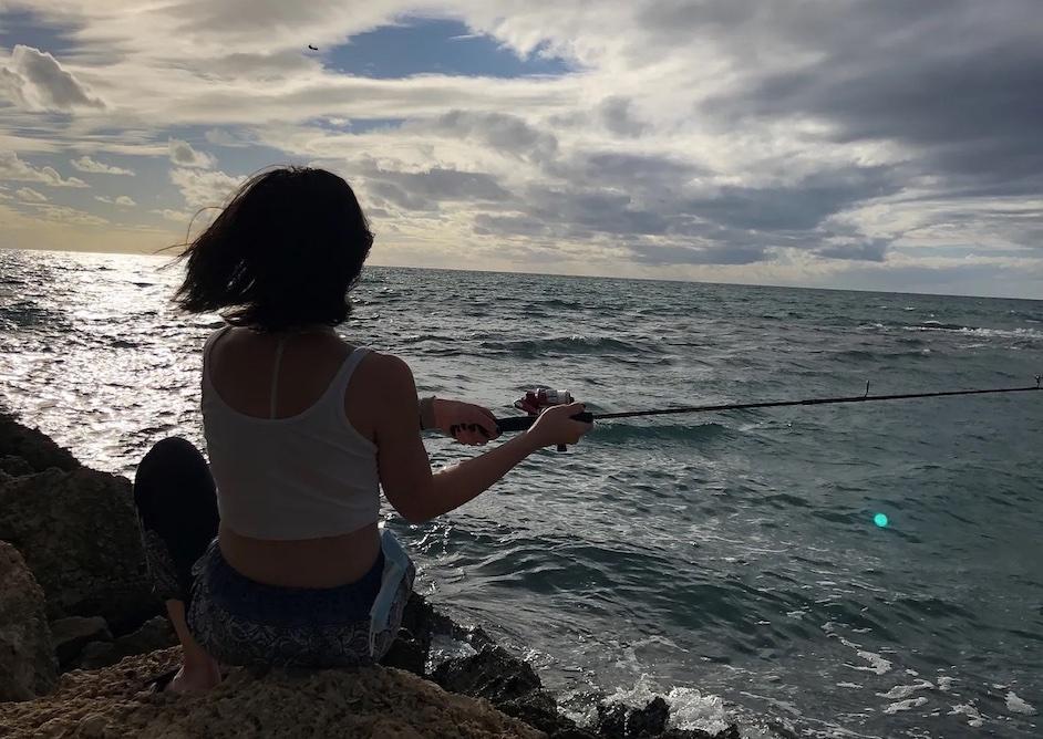 Katy Cooperstein fishing on the sea.