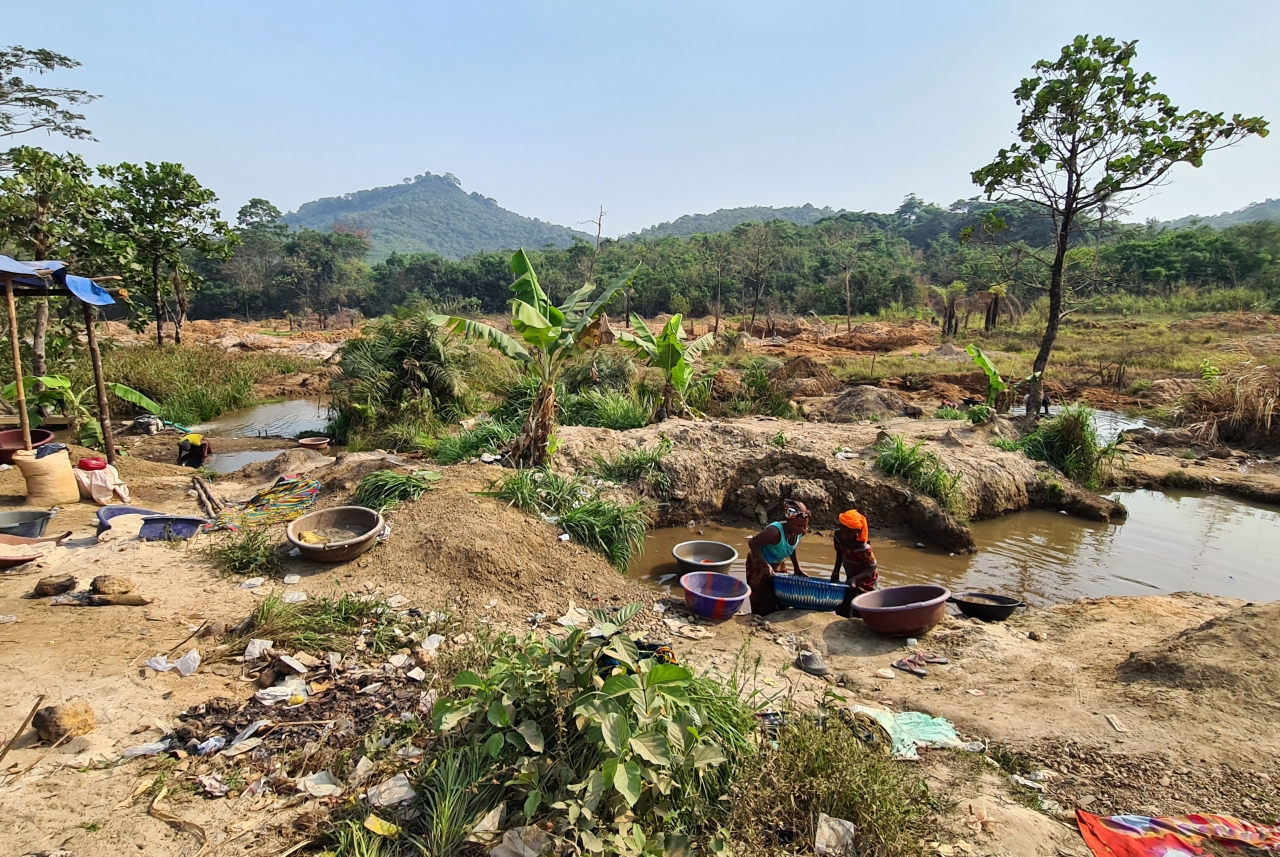 Two people pan for gold outside in Bolaneh, Sierra Leone