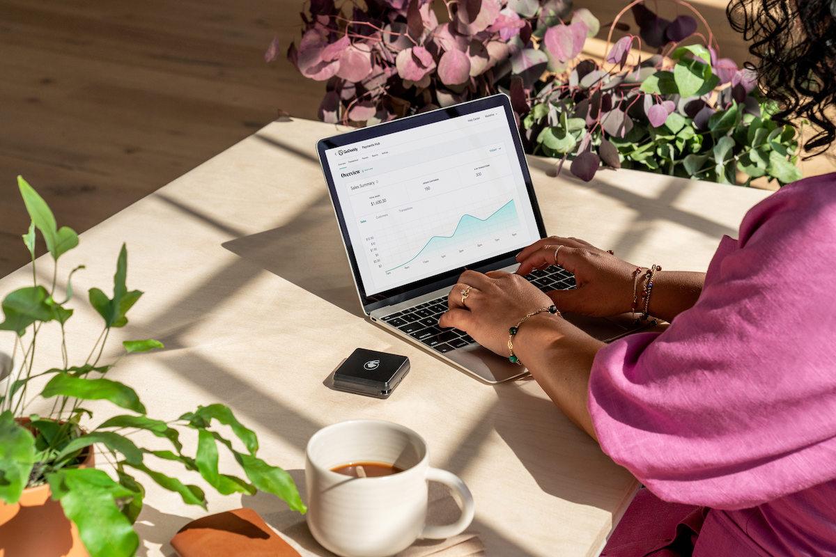 Woman seated at a desk with a laptop.