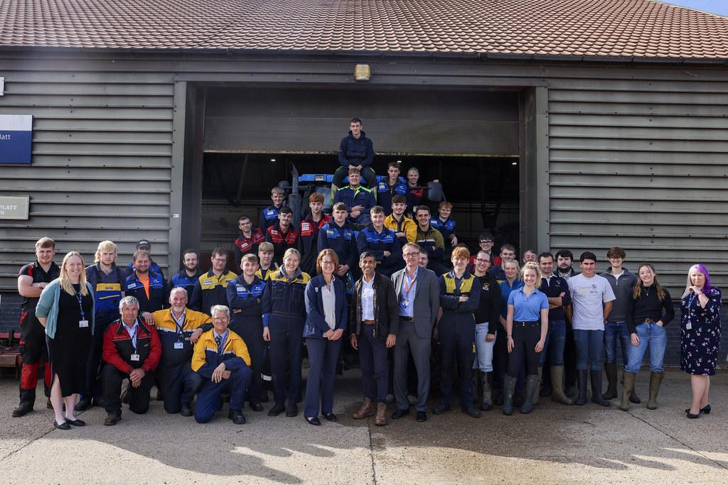 large group photo of UK Prime Minister, Rishi Sunak, with New Holland engineering apprentices 