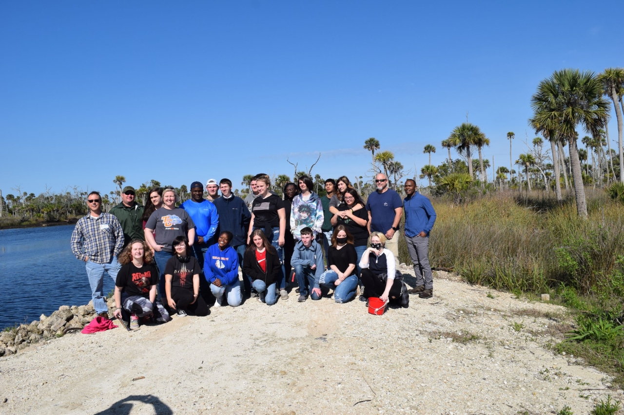 group on a rock by a pond