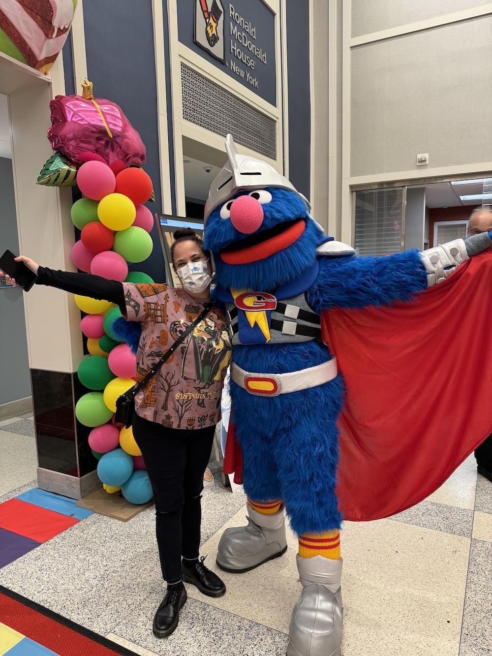 Super Grover poses for a picture 