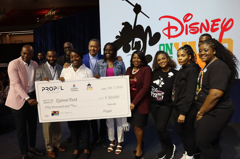 Djahnel Reid receiving a large check for her scholarship at HBCU Week event