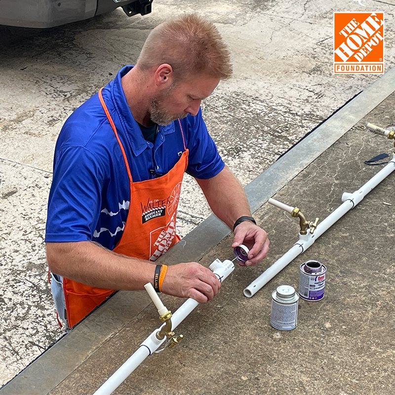 person fixing a pipe