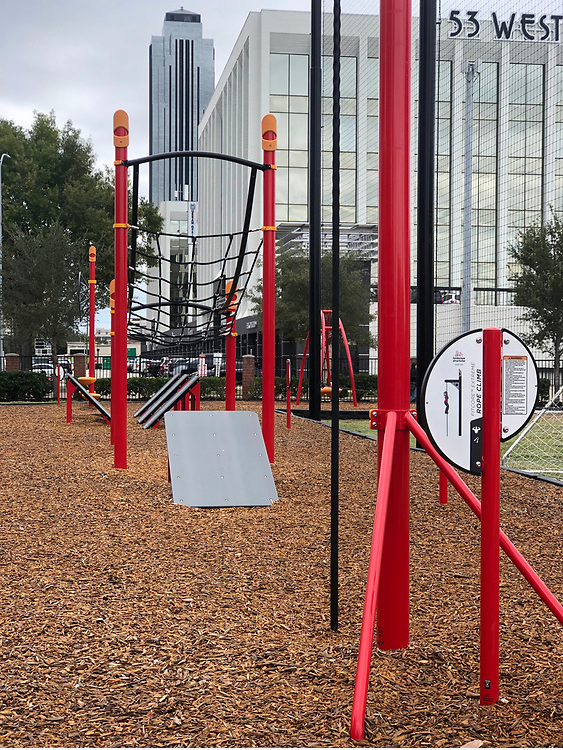 Red obstacle course with buildings in background