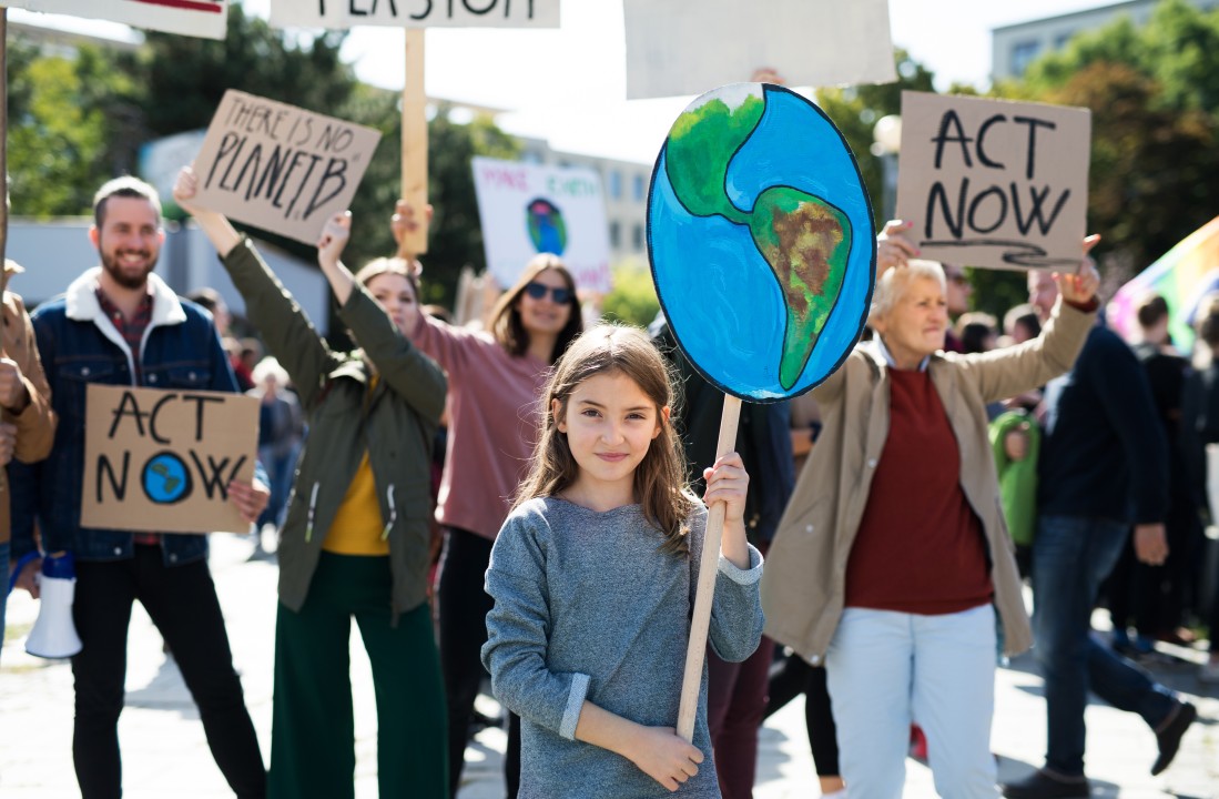 People holding signs for climate change at a protest