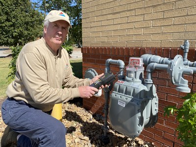 Hayden Barry next to an outdoor gas meter