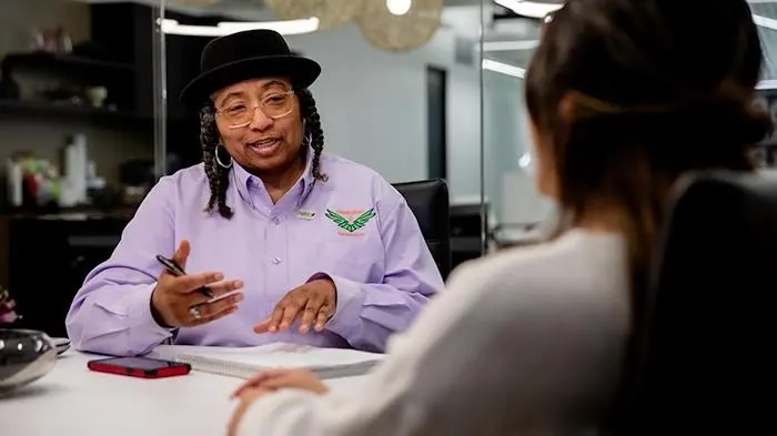 Helen Mathis speaking to a customer
